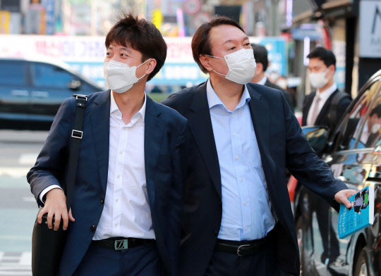 지난 7월25일 오후 윤석열(오른쪽) 전 검찰총장과 이준석(왼쪽) 국민의힘 대표가 서울 광진구 건대 맛의거리에서 '치맥회동'을 하기 위해 음식점으로 향하고 있다.연합뉴스·국회사진기자단